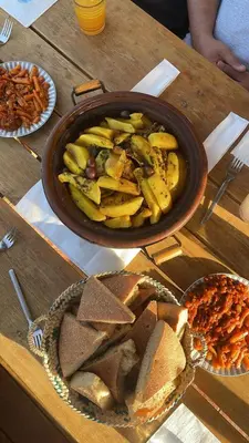 a table with a pan of food and a bowl of food at Ecolodge Vert, Benslimane in Oulad Youssef