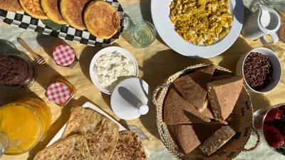 a table topped with lots of different types of food at Ecolodge Vert, Benslimane in Oulad Youssef