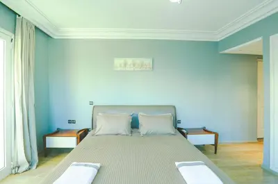 a bedroom with a large bed with blue walls at Beautiful Moroccan apartment Casablanca Center in Casablanca