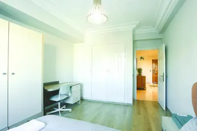 a white bedroom with a desk and a bed at Beautiful Moroccan apartment Casablanca Center in Casablanca