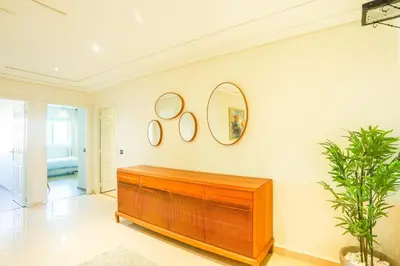a room with a wooden dresser and two mirrors on the wall at Beautiful Moroccan apartment Casablanca Center in Casablanca