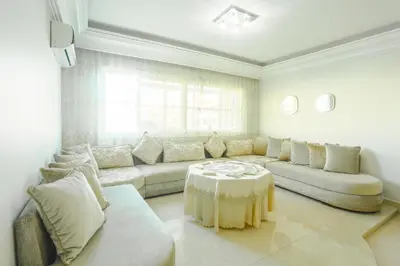 a living room with a couch and a table at Beautiful Moroccan apartment Casablanca Center in Casablanca
