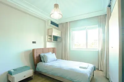 a small bedroom with a bed and a window at Beautiful Moroccan apartment Casablanca Center in Casablanca