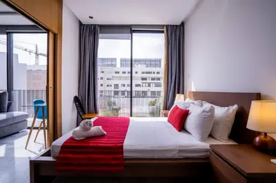a bedroom with a bed and a large window at New urban getaway 25 in Casablanca