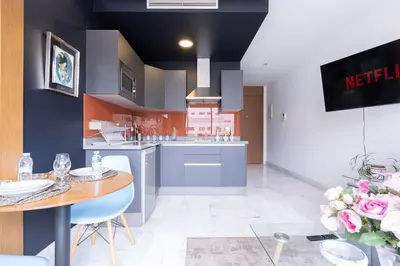 a kitchen with a table and a dining room at New urban getaway 25 in Casablanca