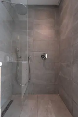 a bathroom with a shower with a glass door at New urban getaway 25 in Casablanca