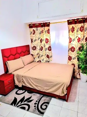a bed with a red headboard in a room at Mi mini estudio 2 in Rabat