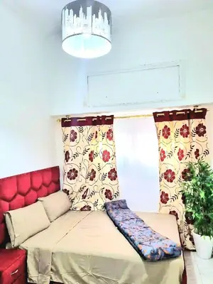 a living room with a couch and a window at Mi mini estudio 2 in Rabat