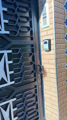a black door with graffiti on the side of a building at Welcome Loc T4 in Casablanca