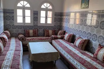 a living room with couches and a table and windows at Welcome Loc T4 in Casablanca