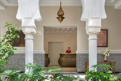 a man sitting at a counter in a lobby at Four Seasons Hotel Rabat at Kasr Al Bahr in Rabat