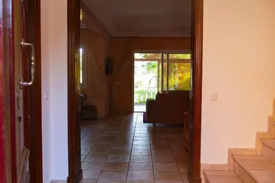 a hallway with a door leading to a living room at Villa luxueuse au centre du golf in Bouznika