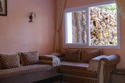 a living room with a couch and a window at Villa luxueuse au centre du golf in Bouznika
