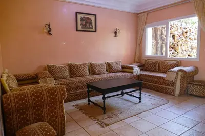 a living room with a couch and a table at Villa luxueuse au centre du golf in Bouznika