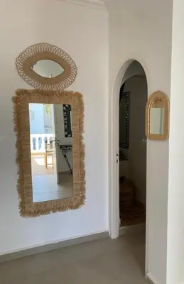 a mirror on a wall in a room at Villa entière Dar Baida Plage David Bouznika in Bouznika