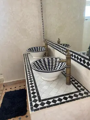 a bathroom with three toilets on a tiled floor at Villa entière Dar Baida Plage David Bouznika in Bouznika