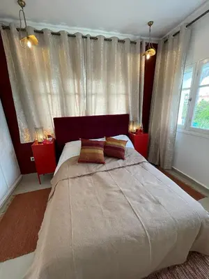 a bedroom with a large bed with two pillows at Villa entière Dar Baida Plage David Bouznika in Bouznika