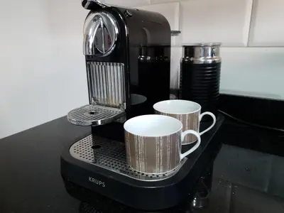 a coffee maker with two coffee cups on a counter at AeroSerenity in Nouaceur