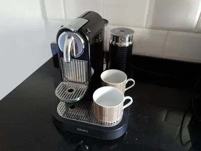 a coffee maker with two cups on a counter at AeroSerenity in Nouaceur