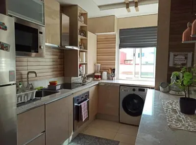 a kitchen with a washer and a sink and a dishwasher at home & room center of rabat in Rabat