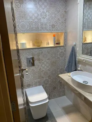 a bathroom with a toilet and a sink at home & room center of rabat in Rabat