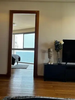 a living room with a television and a view of the ocean at Magnifique appartement pleine vue mer Marina Casablanca in Casablanca