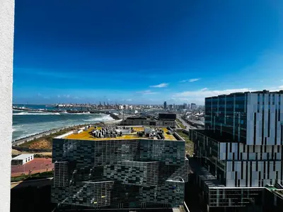 a view of a city and the ocean from a building at Magnifique appartement pleine vue mer Marina Casablanca in Casablanca