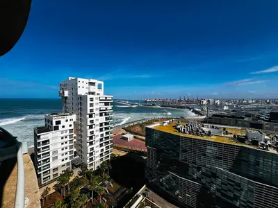 a view of the ocean from a city with tall buildings at Magnifique appartement pleine vue mer Marina Casablanca in Casablanca