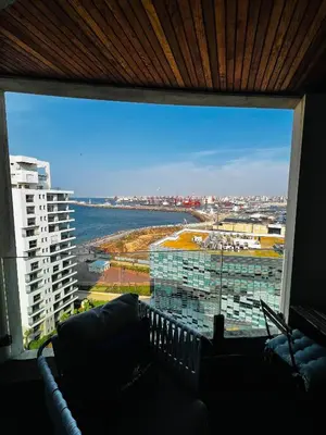 a room with a large window with a view of a building at Magnifique appartement pleine vue mer Marina Casablanca in Casablanca