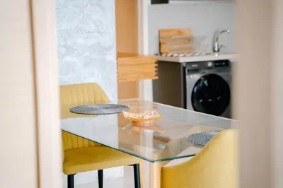 a kitchen with a glass table and two chairs at Luxurious Close to all attractions in Casablanca