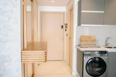 a kitchen with a washer and dryer next to a door at Luxurious Close to all attractions in Casablanca