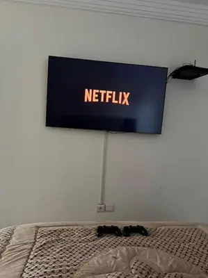 a netflix sign on a wall above a bed at appartement meublé in Mohammedia