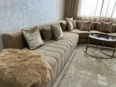 a living room with a couch and a table at appartement meublé in Mohammedia