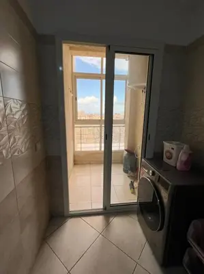 a bathroom with a window and a washing machine at appartement meublé in Mohammedia
