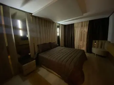 a bedroom with a bed and a chair in a room at Corniche Casablanca- Golden Hour in Casablanca