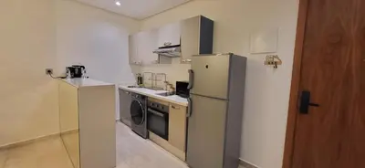 a small kitchen with a refrigerator and a dishwasher at Le Bijou du Maarif in Casablanca