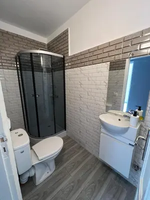 a bathroom with a toilet and a sink and a shower at Appartement très équipé etpropre 1 in Camp de Mediouna