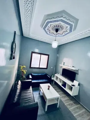 a living room with a couch and a table at Appartement très équipé etpropre 1 in Camp de Mediouna