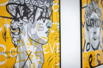 a group of drawings on a yellow wall at Appartement Duplex G1 in Casablanca