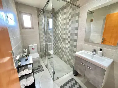 a bathroom with a shower and a sink and a toilet at A2 Luxe Moderne et Confort, 7 min du Stade Moulay Abdellah in Temara