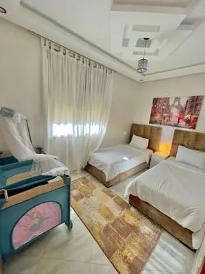 a bedroom with two beds and a window at A2 Luxe Moderne et Confort, 7 min du Stade Moulay Abdellah in Temara