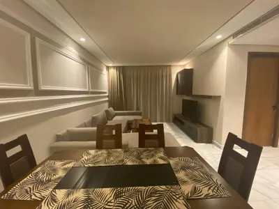 a living room with a table and a couch at Hilbert Princesses - Furnished apartments in Casablanca