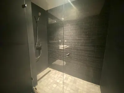 a bathroom with a shower with a glass door at Hilbert Princesses - Furnished apartments in Casablanca