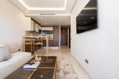 a living room with a couch and a table at Maarif princess amazing one bedroom flat in Casablanca
