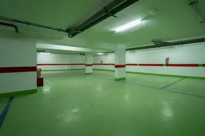 an empty parking garage with red and white walls at Maarif princess amazing one bedroom flat in Casablanca