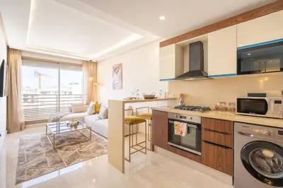 a kitchen and living room with a couch and a stove at Maarif princess amazing one bedroom flat in Casablanca