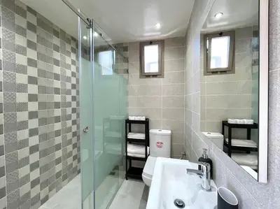 a bathroom with a sink and a shower and a toilet at A3 Luxe and Cosy Apartement, 7 min du Stade Moulay Abdellah in Temara