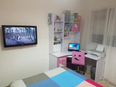 a bedroom with a desk with a computer and a tv at High-End Apartment with Terrace in Val Fleuri, Maarif Casablanca, Ideal for Families & Business Travelers in Casablanca