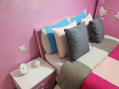 a room with a couch with pillows and a table at High-End Apartment with Terrace in Val Fleuri, Maarif Casablanca, Ideal for Families & Business Travelers in Casablanca