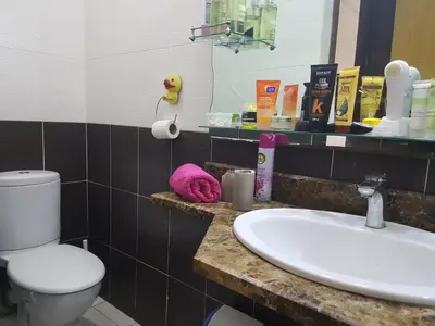 a bathroom with a sink and a toilet and a mirror at High-End Apartment with Terrace in Val Fleuri, Maarif Casablanca, Ideal for Families & Business Travelers in Casablanca